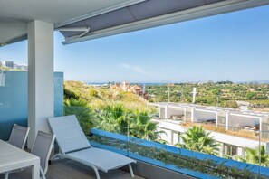 A balcony with a view of a cityscape and greenery. - Han | Mountain view - pool - terrace (Estepona)