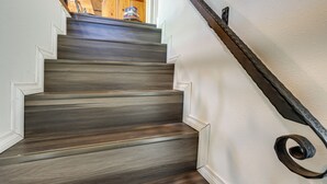 Un escalier avec des marches en bois et une rampe métallique.