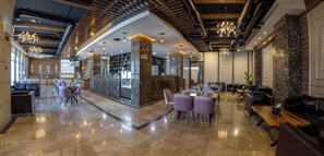 A modern hotel lobby with marble flooring, seating areas, and a reception desk. - Jeddah Homes Boutique Hotel (Amman)