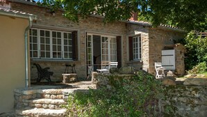 A stone house with large windows, a stone staircase, and outdoor seating. - Le Tilleul - JALOGNY (JALOGNY)