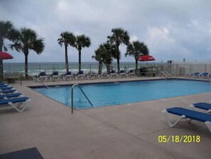 Relax by the pool with ocean views and comfortable lounge seating.