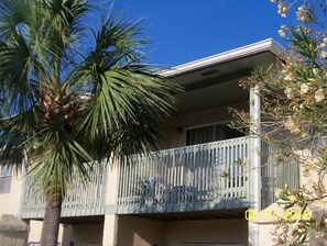 Guests can enjoy a balcony with vertical slats overlooking the surrounding area.