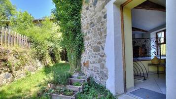 A stone wall, wooden steps, and a metal railing.