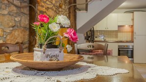 A dining table with a woven basket containing a potted plant labeled "Plants" and a lace tablecloth. - Lovely home in Moscenicka Draga with WiFi (Moscenicka Draga)