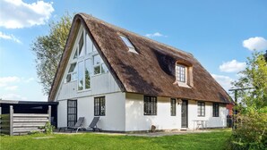A large, white, two-story house with a steeply pitched roof and a thatched roof section. - Lake front home in Rømø with WiFi (Rømø)