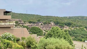 A residential area with multiple apartment buildings, surrounded by greenery and hills. - Superior two-room apartment with 4 beds (40 m2) with living-dining room and double sofa bed or two separate sofa beds or 2 built-in beds, double bedroom.The apartments have spaceoutside (balcony if on the first floor and terrace if on the ground floor) w (Olbia)