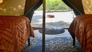 A tent with two beds, a central pole, and a view of an outdoor area with a fire pit. - Sequoia Jewel -16 Foot Bell Tent with double beds. 4.5 to Sequoia National Park. (Three Rivers)