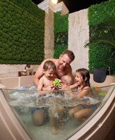 A hot tub with three people enjoying the water.