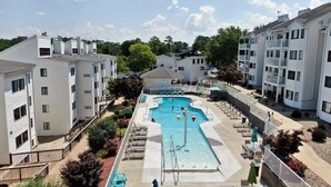A residential building with a swimming pool, balconies, and a clear sky. - Breathtaking Lake & Pool Views, In Osage Beach! (Osage Beach)