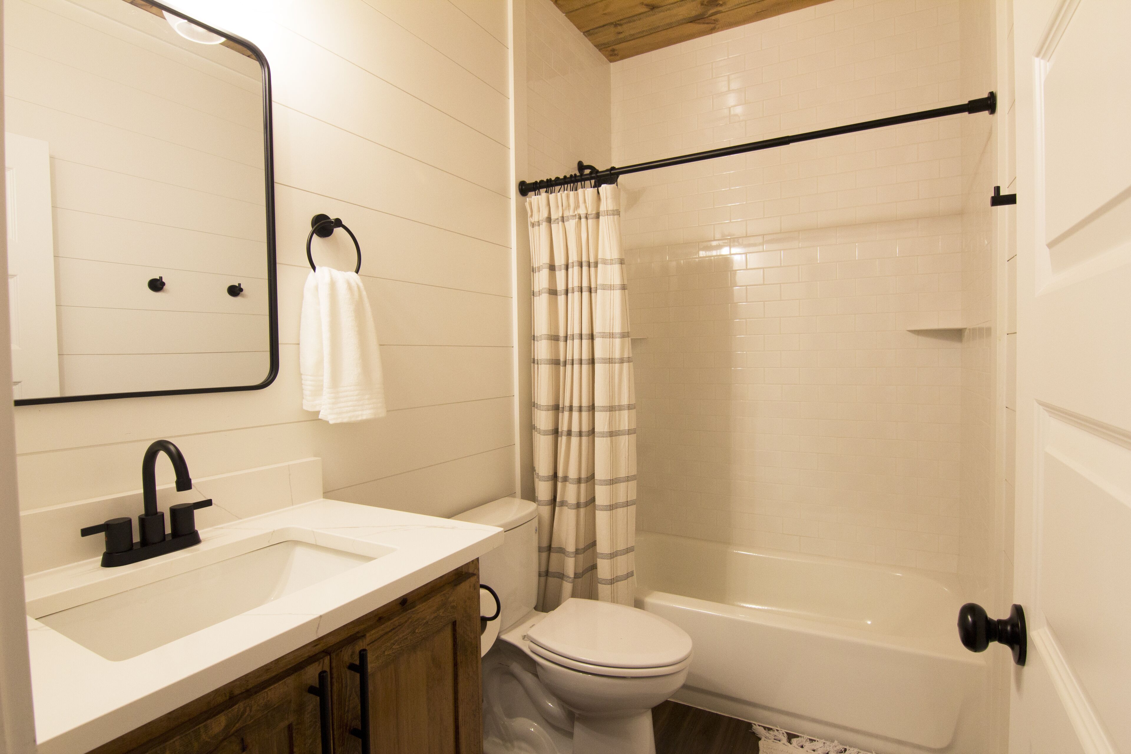 A bathroom with a white sink, a toilet, and a bathtub.