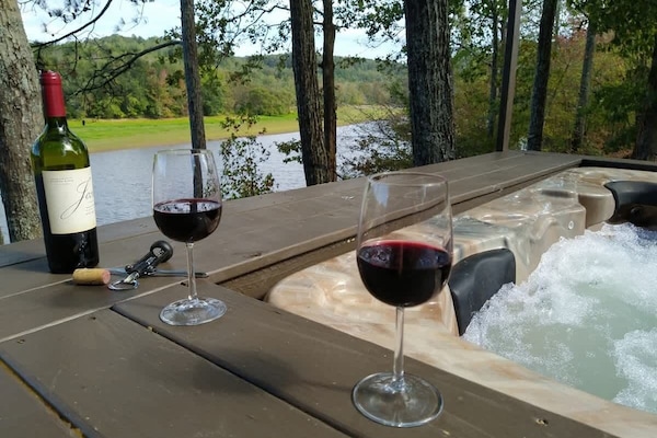 Soak in the hot tub by the lake.