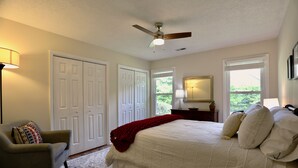 A bedroom with a bed, a chair, a ceiling fan, and a window. - Cheerful Eclectic Pinehurst Home! Less than 2 miles from Pinehurst #1-4 (Pinehurst)