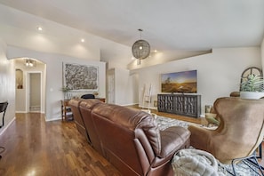 Relax in this stylish living area with a sofa, armchair, and flat-screen TV.