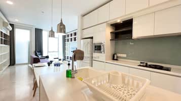Two Bedroom Apartment | Living area | 32-inch flat-screen TV with cable channels, TV, Netflix
