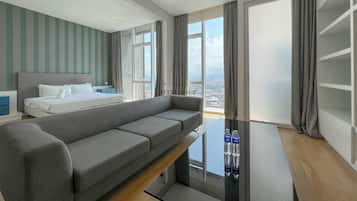 Deluxe One Bedroom Apartment | Living area | 32-inch flat-screen TV with cable channels, TV, Netflix