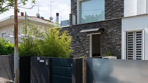 A modern house with a stone facade, a metal gate, and a small garden. - La Casa di Guido in Gabicce Mare (Gabicce Mare)