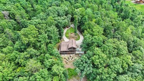 An aerial view of a cabin surrounded by dense forest, with a clear driveway leading to the entrance. - Valley Retreat! Sleeps 10 ~ Hot Tub ~ Fire Pit (Blue Ridge)