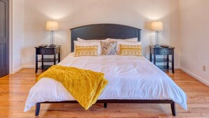 A bedroom with a large bed, two bedside tables, and a wooden ceiling. - Valley Retreat! Sleeps 10 ~ Hot Tub ~ Fire Pit (Blue Ridge)