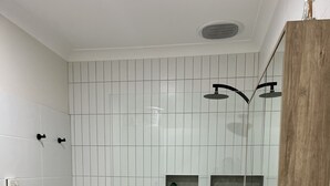 A modern bathroom with a large white sink, a wooden vanity, and a mirror. - Tuscan Villa in Myrtleford (Myrtleford)