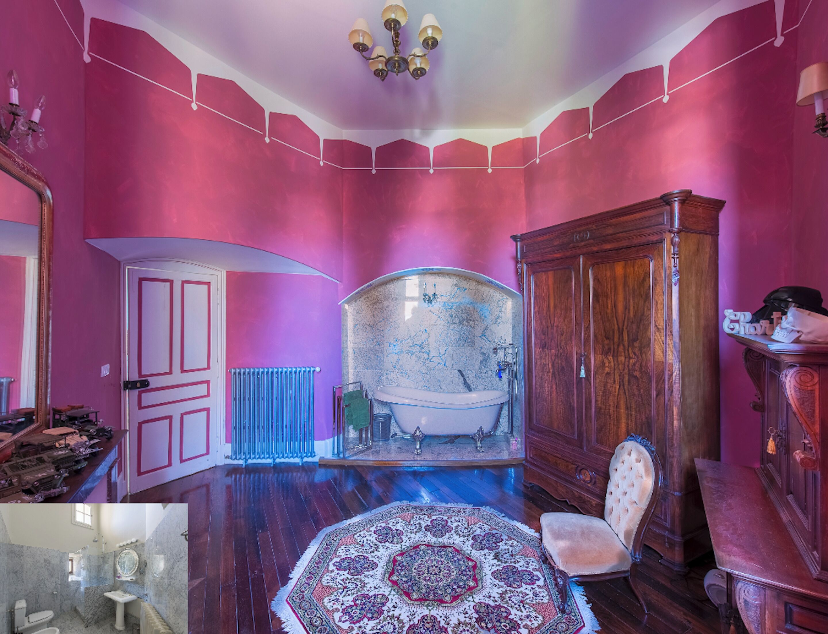 A room with a vintage bathtub, a wooden cabinet, and a patterned rug.