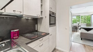 A modern kitchen with a built-in oven and a coffee machine. - Apartment BERGBLICK (Bad Reichenhall)