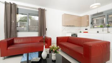 Deluxe House | Living area | 45-inch LED TV with cable channels, TV, heated floors