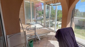 A room with a bed, a chair, a window, and a view of the outdoors. - Exclusive Apartment Sun and Sea  (Novalja)