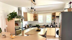 A modern kitchen with a central island, built-in oven, and stainless steel appliances. - Beautiful bask villa close to Bidart Guethary Biarritz beaches (Ahetze)