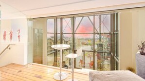 A modern interior with a glass wall, a round table, and a chair.