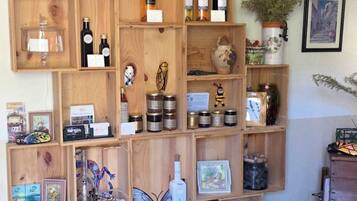A wooden display shelf with various items including bottles, jars, and decorative objects.