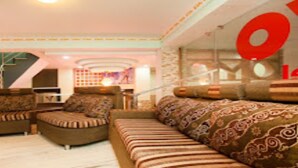A living room with a sofa, armchairs, and a patterned rug. - MeroStay 210 Hotel Tone (Kathmandu)