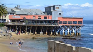 A pier extending into the water with a restaurant on it. - 3896 Gather and Rest - Mountain Views, Large Patio (Del Rey Oaks)