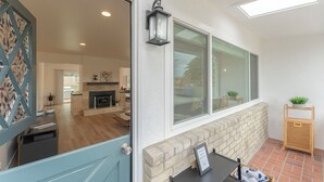 A modern interior with a fireplace, a dining area, and a view through large windows. - 3896 Gather and Rest - Mountain Views, Large Patio (Del Rey Oaks)
