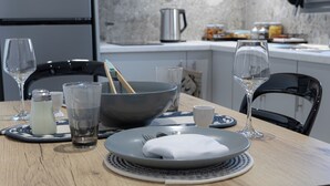 A dining table set with plates, glasses, and cutlery.