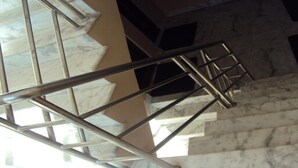 A marble staircase with metal railings, leading to an upper floor. - MeroStay 251 Hotel Air (Kathmandu)