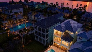 A multi-story house with a swimming pool and a deck area. - Oceanfront 6 Bedroom Heated Pool Home in Cinnamon Beach! Barefoot Sands!! (Palm Coast)