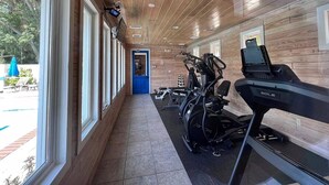 A gym with exercise equipment, wooden walls, and large windows. - Yellowfin in the Steinhatchee Landing (Steinhatchee)