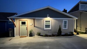 A single-story house with a front door, a small porch, and a driveway.