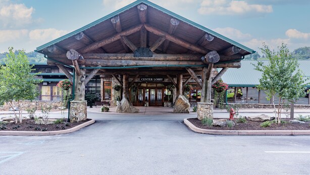 A lodge with a covered lobby, stone pillars, and a sign reading "CENTER LOBBY".