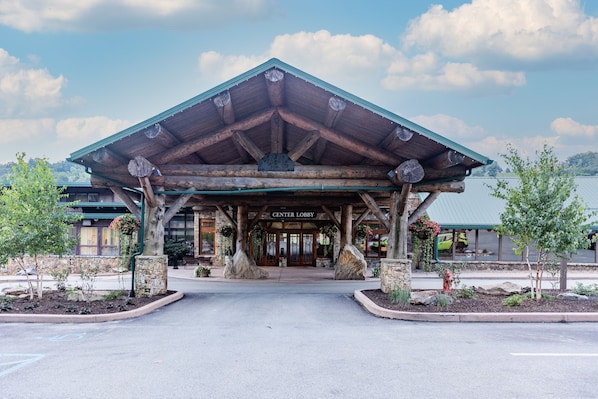 A lodge with a covered lobby, stone pillars, and a sign reading "CENTER LOBBY".
