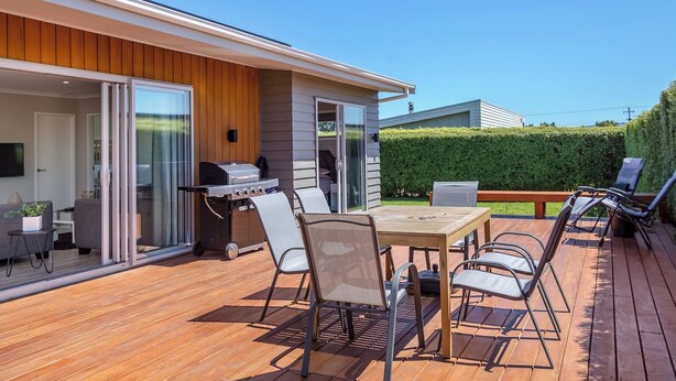 An outdoor deck with a grill, dining table, and chairs. - 27 Tuscan, Martinborough (Martinborough)