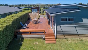 A deck with outdoor furniture, a barbecue area, and a view of the surrounding landscape. - 27 Tuscan, Martinborough (Martinborough)