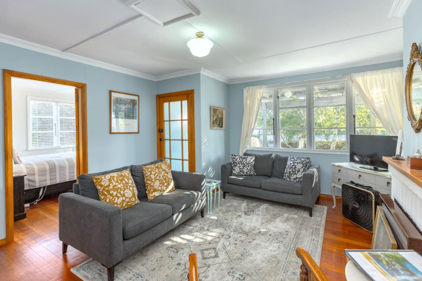 A living room with two sofas, a coffee table, a TV, and a fireplace.