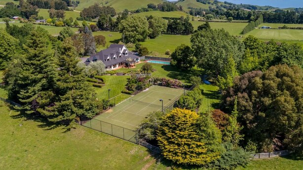 A residential property with a tennis court, surrounded by lush greenery and hills. - Longbush Estate, Gladstone (Longbush)