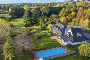 A residential property with a swimming pool, tennis court, and landscaped garden. - Longbush Estate, Gladstone (Longbush)