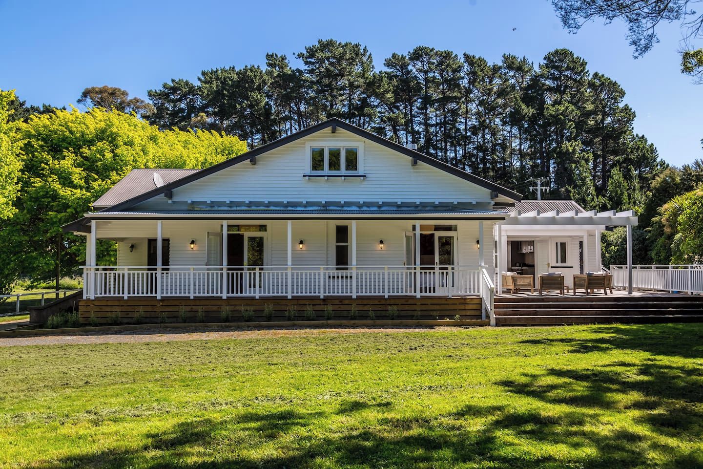 A two-story house with a porch and a covered patio area.