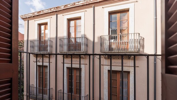 A building with multiple balconies and windows.