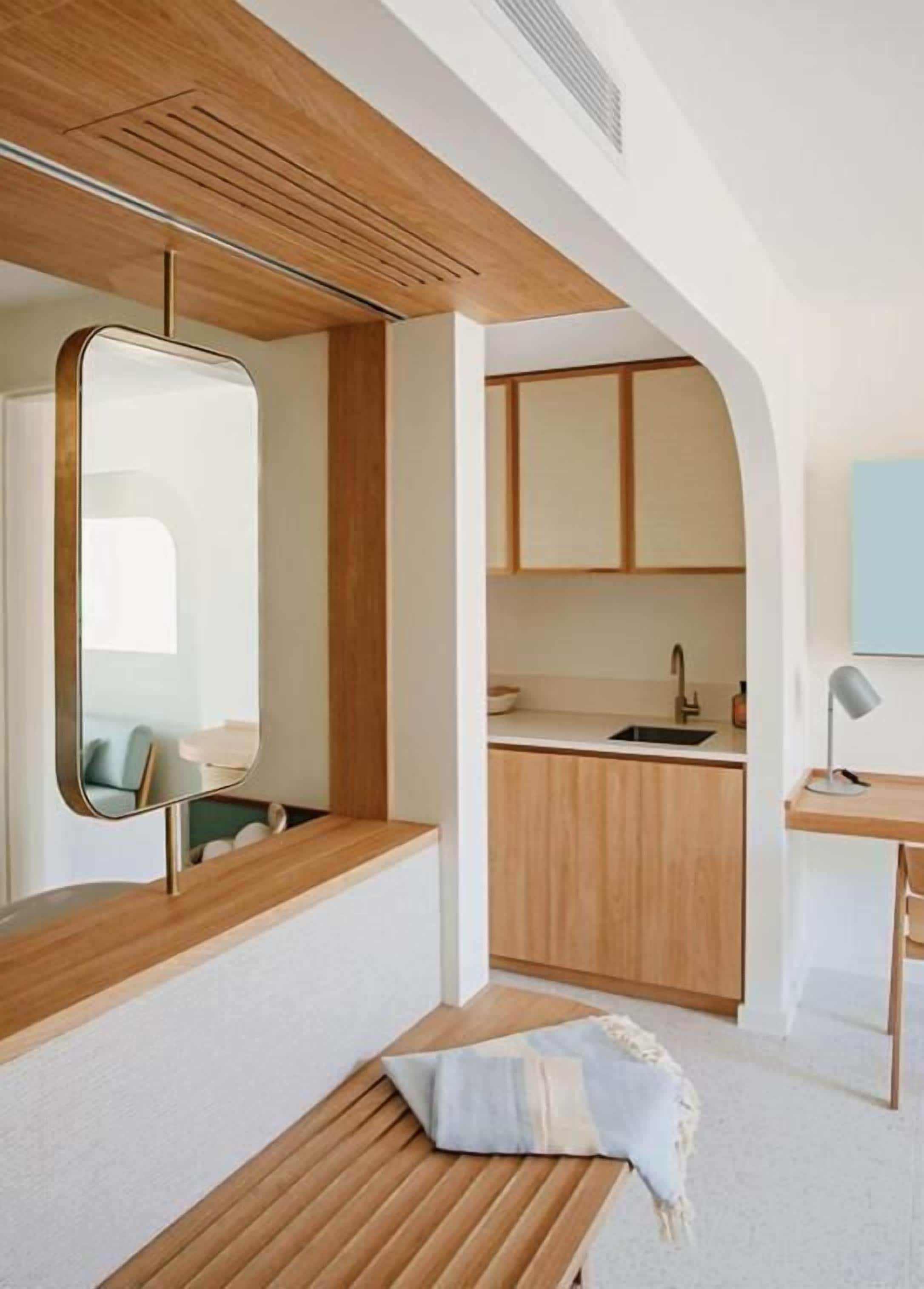 A modern kitchen with wooden cabinets, a sink, and a countertop.
