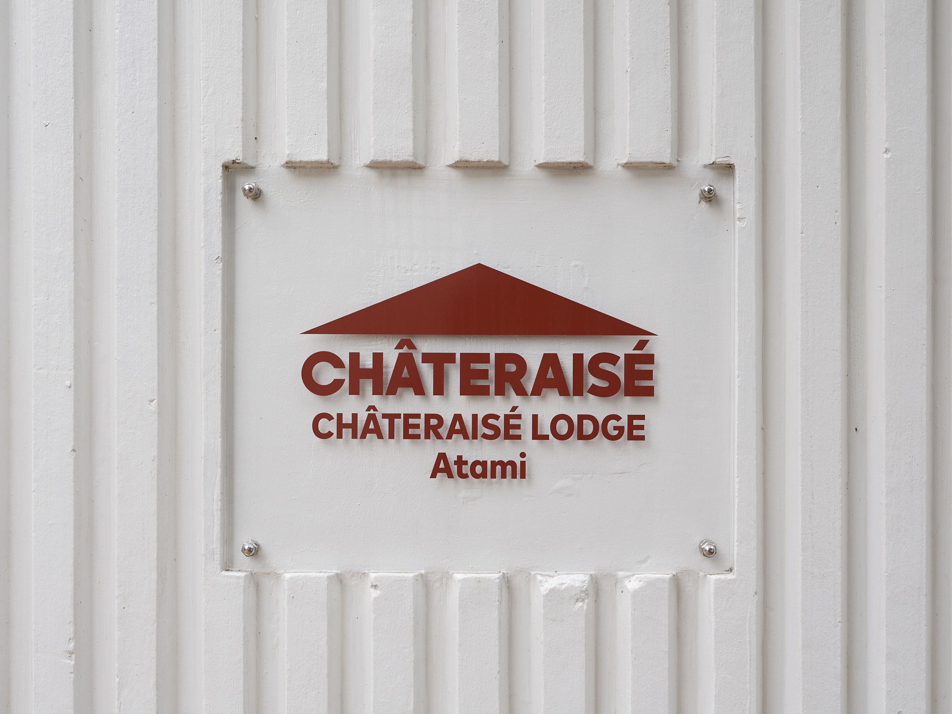 A sign with the text "CHÂTERAISÉ CHÂTERAISÉ LODGE Atami" on a white background.