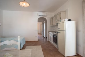 A compact kitchen with a refrigerator, oven, and sink. - Superb Le Residenze del Golfo di Orosei B4 -1 Bedroom apartment sleeps 4 persons (Orosei)